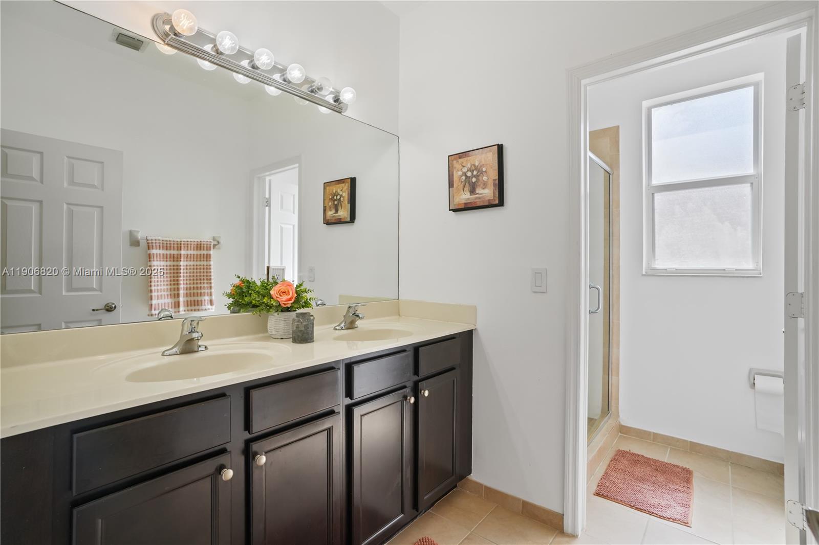 9127 Southwest 171st Court Miami, FL 33196 - Photo 7 of 54 a bathroom with a sink and a mirror