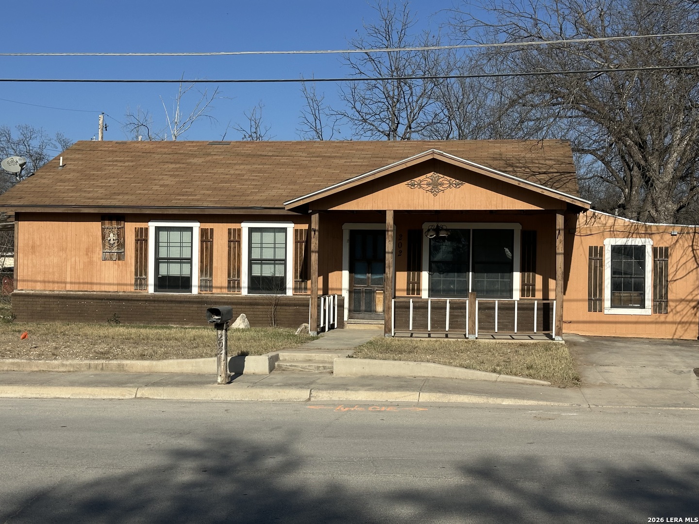 a front view of a house with a sitting area