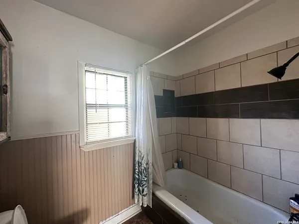 a bathroom with a bathtub and window
