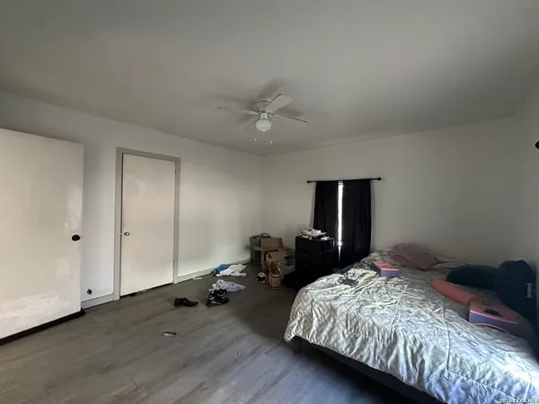 a bedroom with a bed and a chandelier
