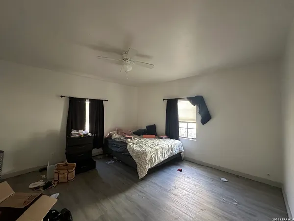 a bedroom with a bed and wooden floor