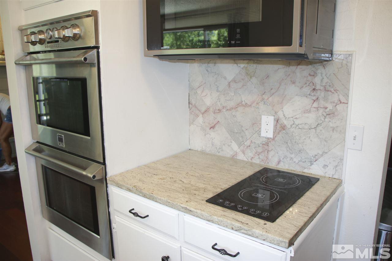 4100 Lakeside Drive Reno, NV 89509 - Photo 12 of 21 a stove top oven sitting inside of a kitchen
