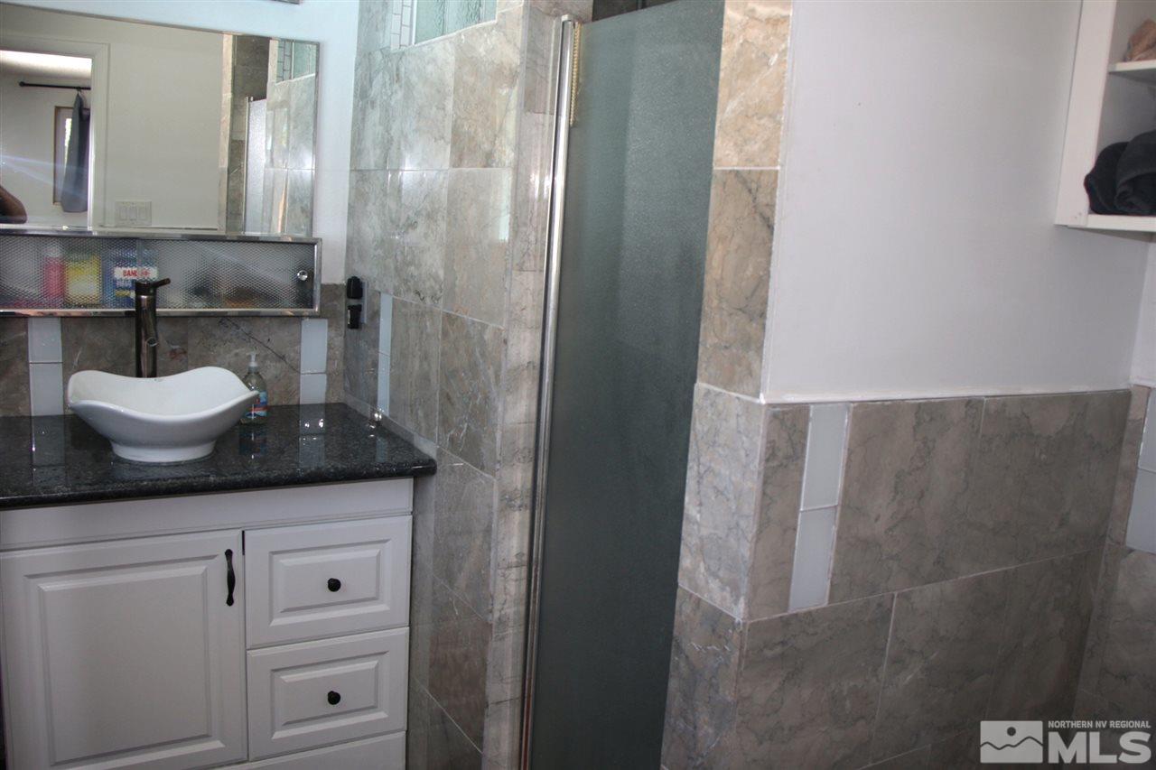 4100 Lakeside Drive Reno, NV 89509 - Photo 20 of 21 a bathroom with a granite countertop sink and a mirror