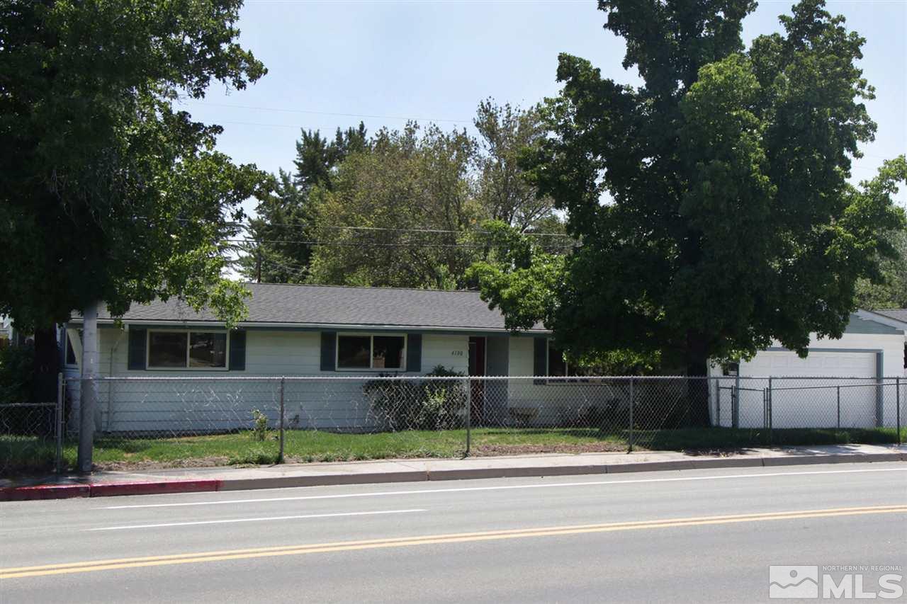 4100 Lakeside Drive Reno, NV 89509 - Photo 2 of 21 a front view of a house with a yard and garage