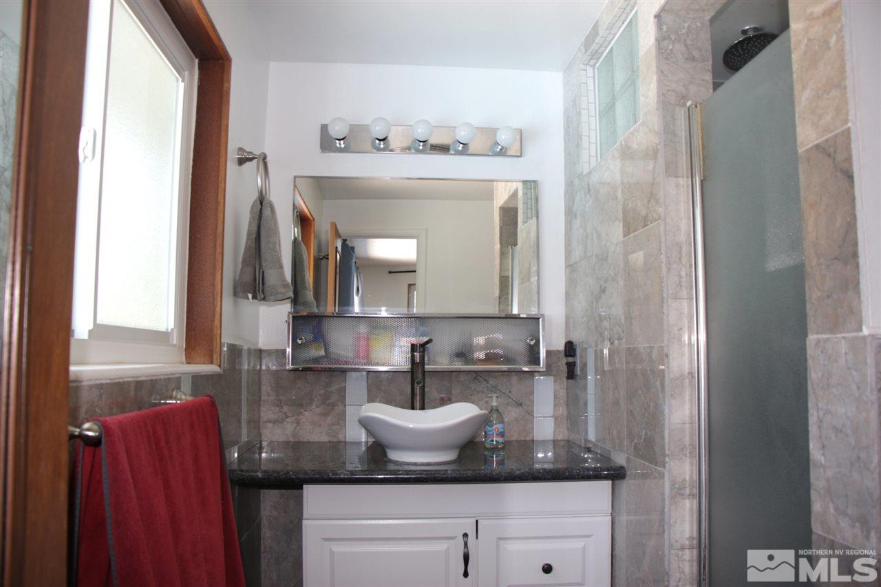 4100 Lakeside Drive Reno, NV 89509 - Photo 21 of 21 a bathroom with a granite countertop sink and a mirror