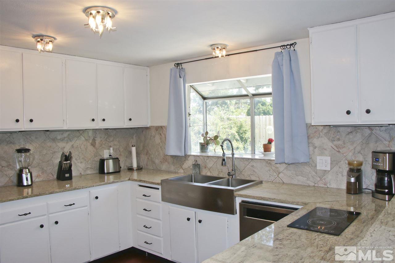 4100 Lakeside Drive Reno, NV 89509 - Photo 10 of 21 a kitchen with cabinets appliances a sink and a window