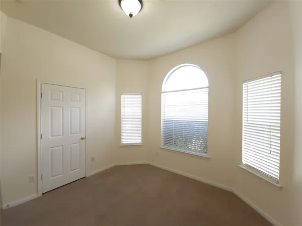 an empty room with windows and closet