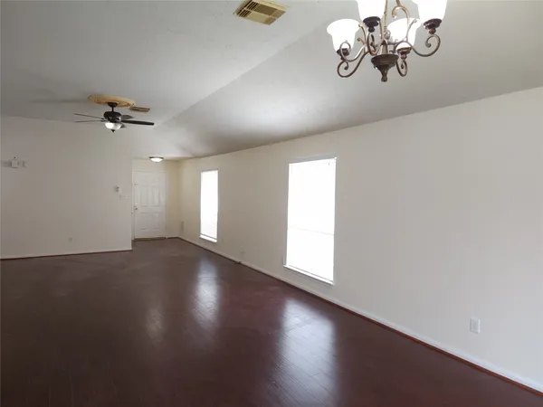 a view of a chandelier fan and wooden floor