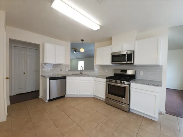 a kitchen with a sink cabinets and window