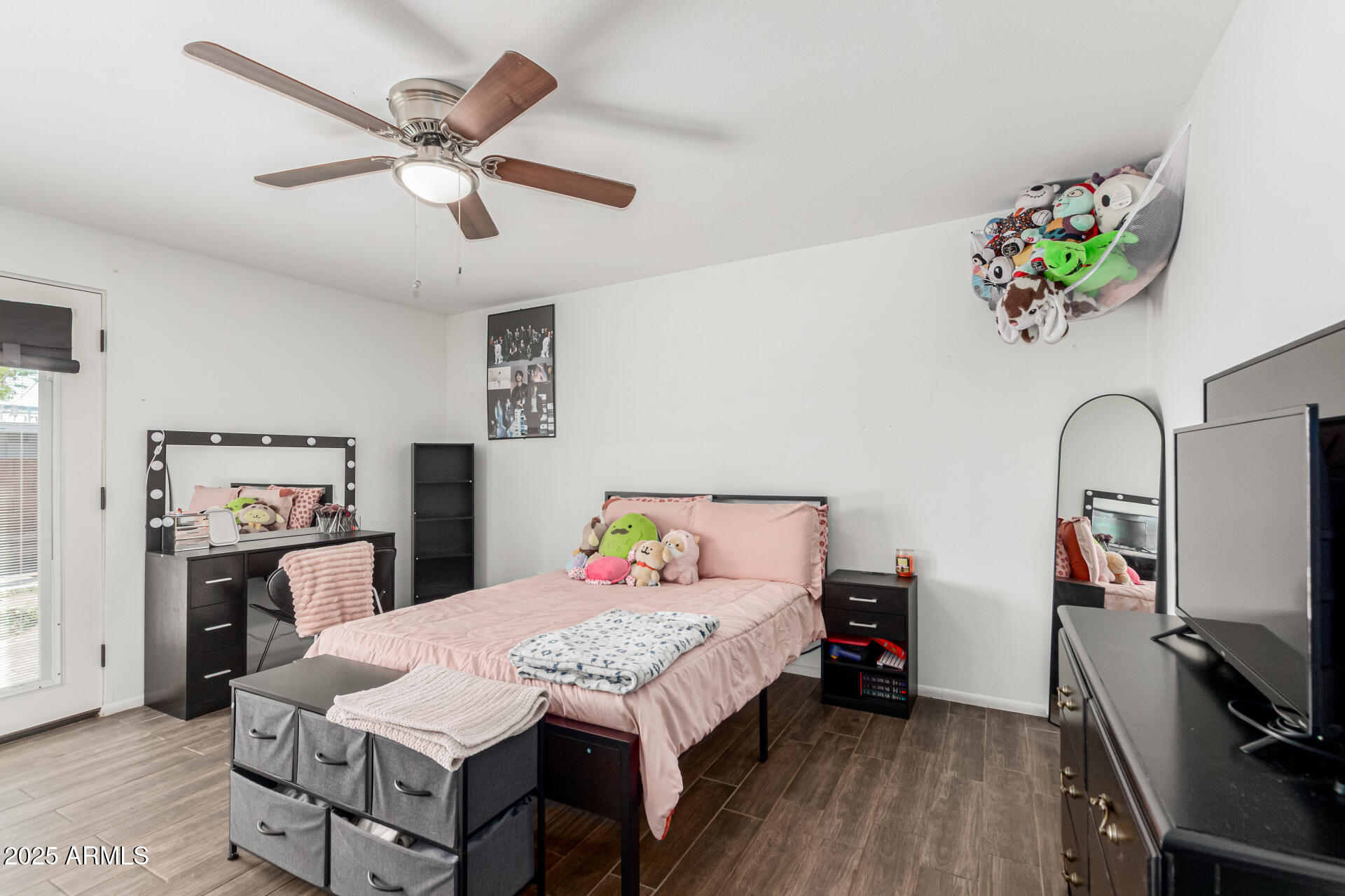 3701 West Griswold Road Phoenix, AZ 85051 - Photo 16 of 30 a bed room with a bed and a flat screen tv