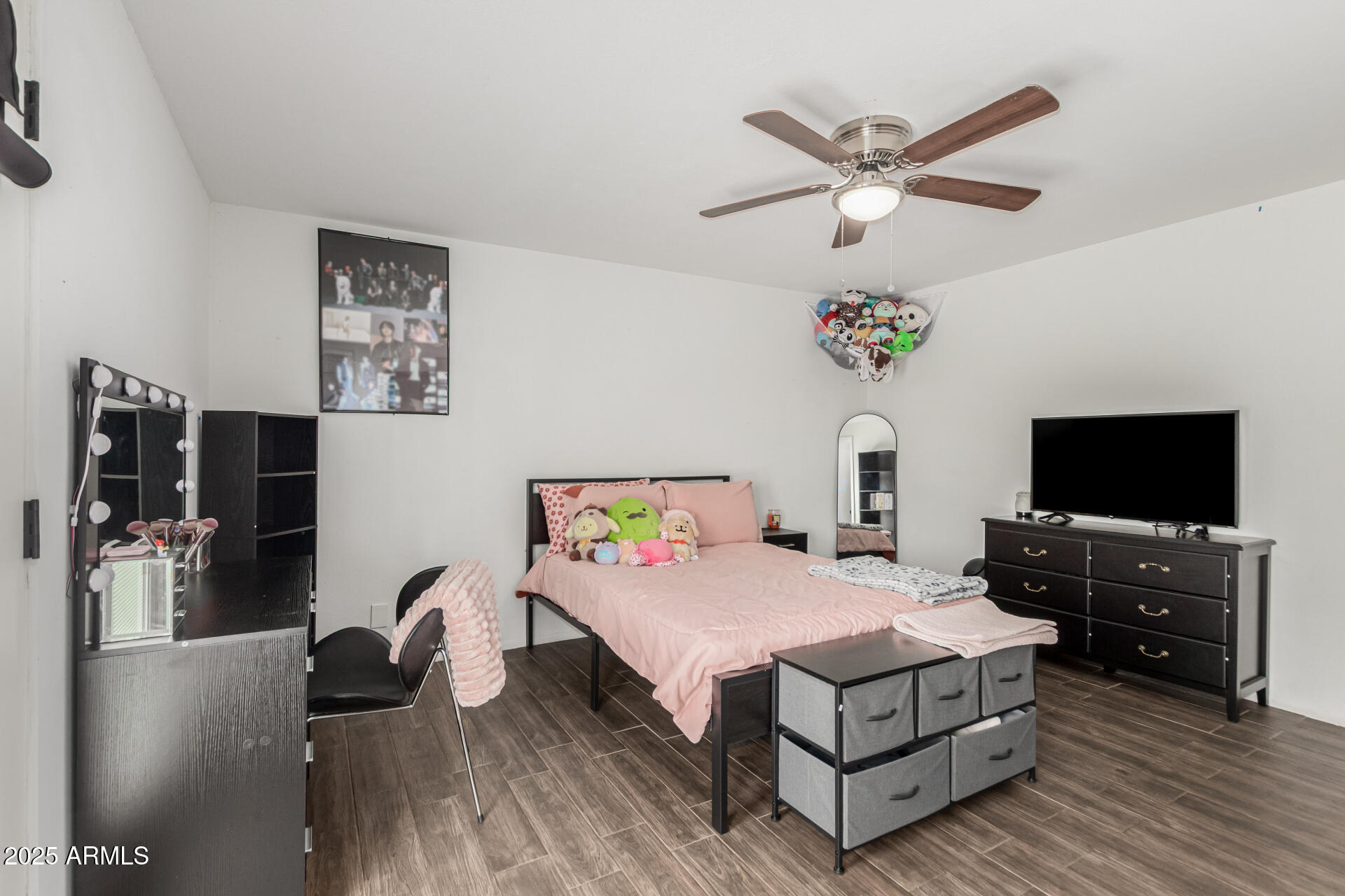 3701 West Griswold Road Phoenix, AZ 85051 - Photo 17 of 30 a bedroom with a bed and a flat screen tv