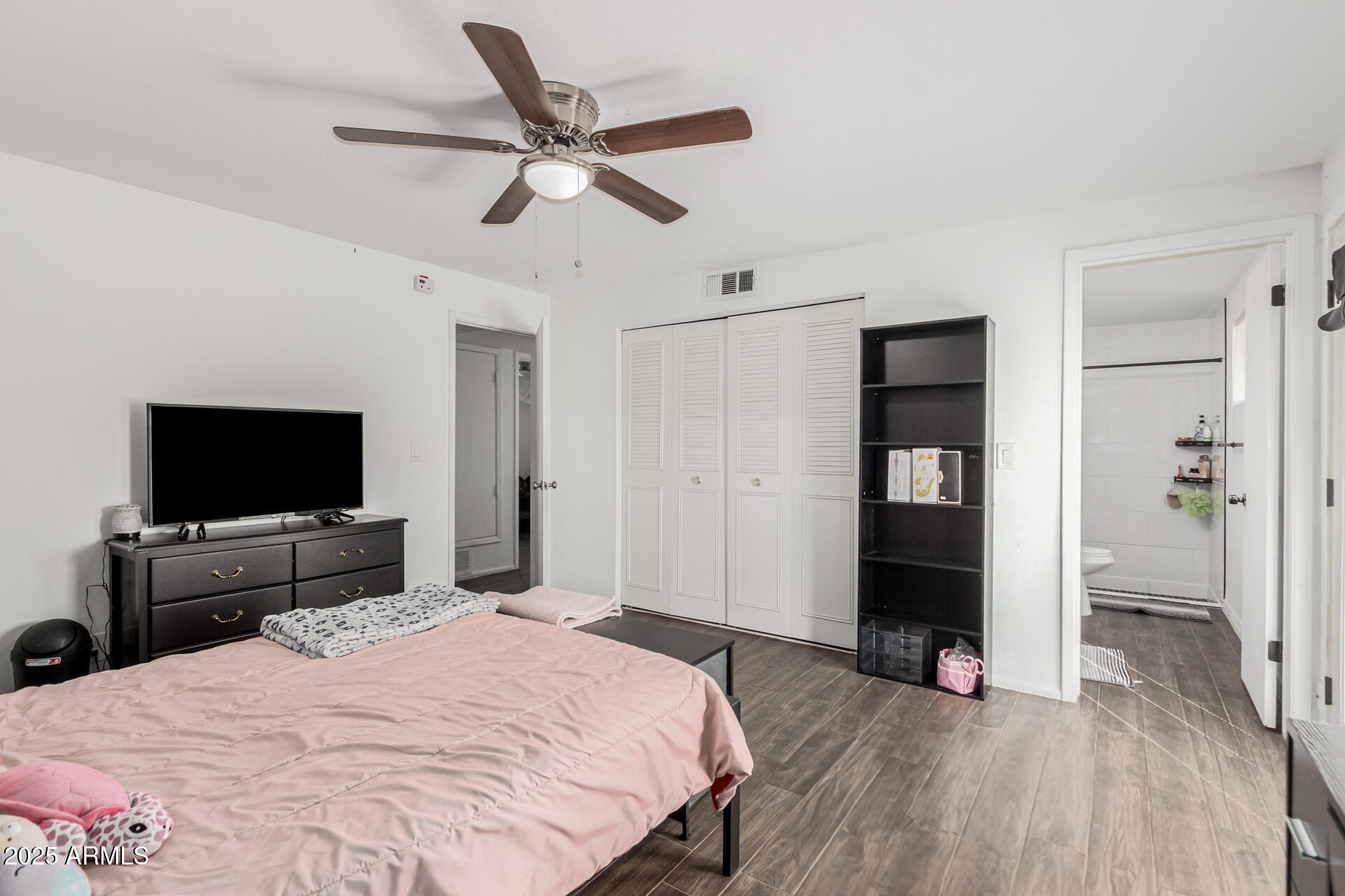 3701 West Griswold Road Phoenix, AZ 85051 - Photo 18 of 30 a bedroom with a bed and a flat screen tv