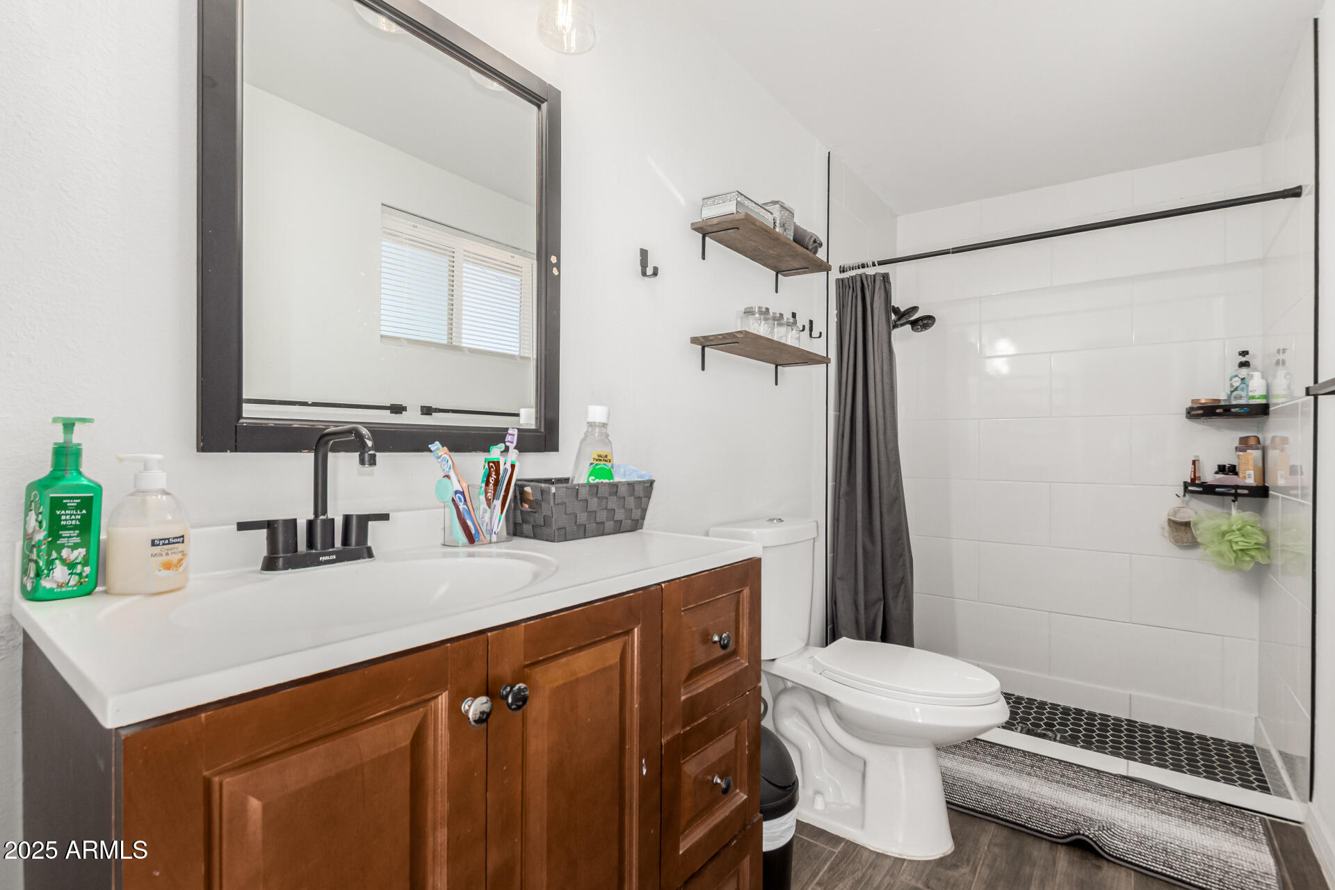 3701 West Griswold Road Phoenix, AZ 85051 - Photo 19 of 30 a bathroom with a sink a toilet and shower