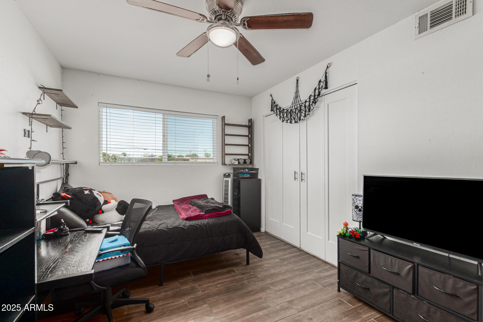 3701 West Griswold Road Phoenix, AZ 85051 - Photo 20 of 30 a bedroom with furniture and a flat screen tv