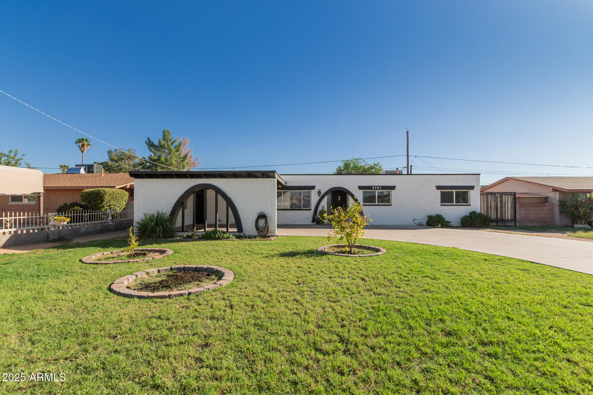 3701 West Griswold Road Phoenix, AZ 85051 - Photo 2 of 30 a front view of a house with garden