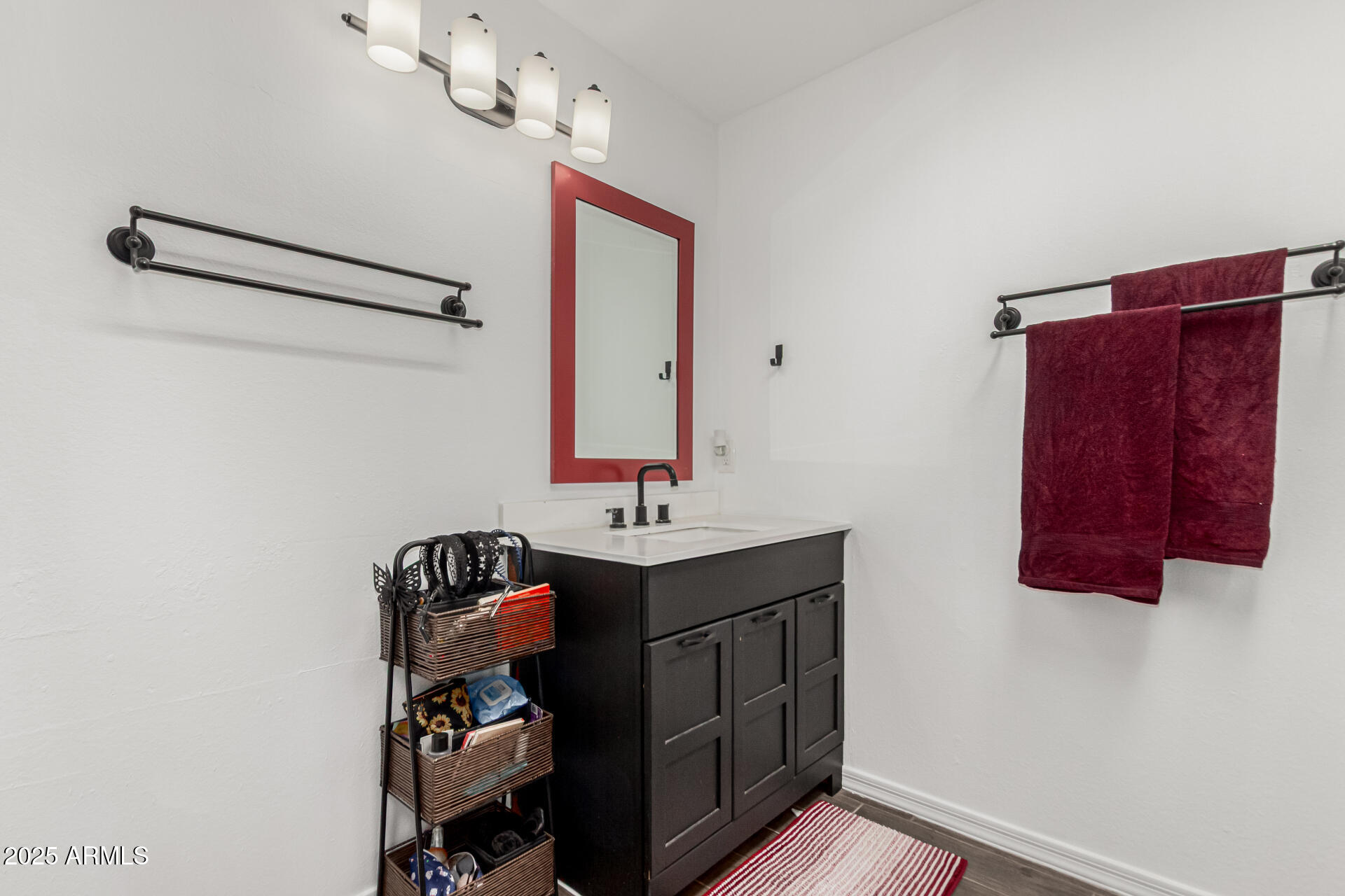 3701 West Griswold Road Phoenix, AZ 85051 - Photo 25 of 30 a bathroom with a sink and a mirror