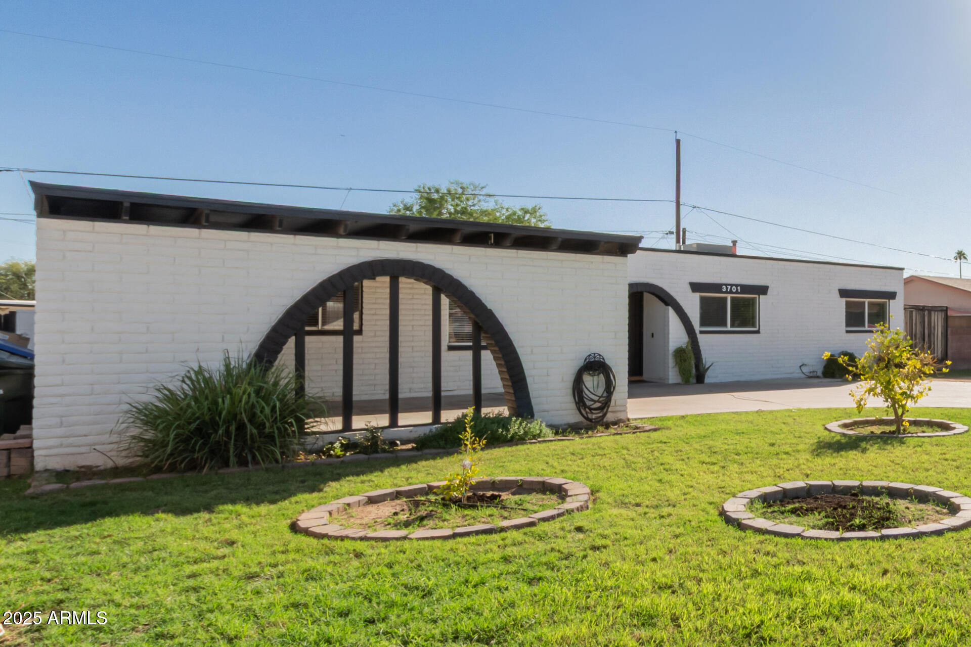 3701 West Griswold Road Phoenix, AZ 85051 - Photo 3 of 30 a front view of a house with garden