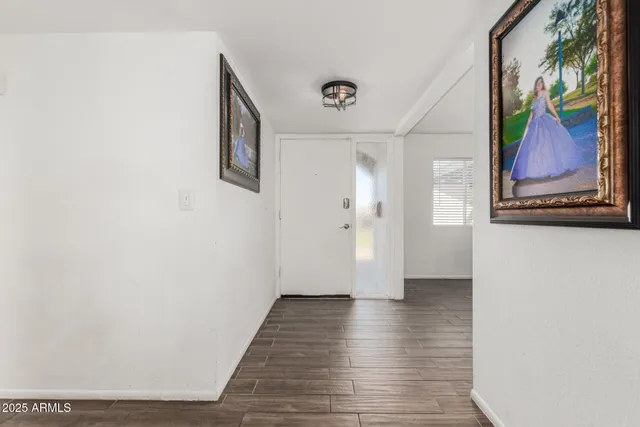 a view of a hallway with wooden floor