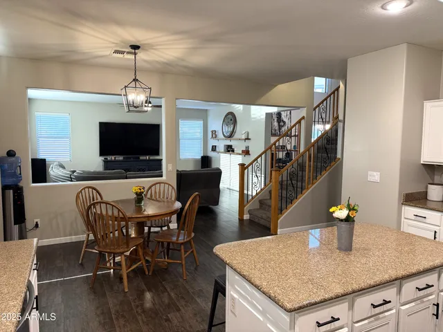 a kitchen with stainless steel appliances granite countertop a stove a sink dishwasher and cabinets with wooden floor