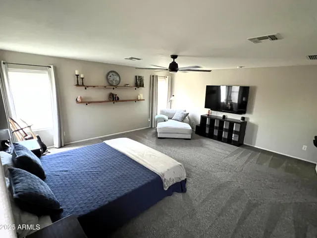 a spacious bedroom with a bed and a couch