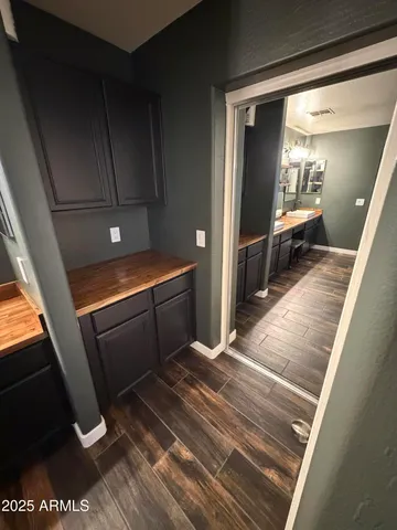 a room with stainless steel appliances kitchen island granite countertop a refrigerator and a stove