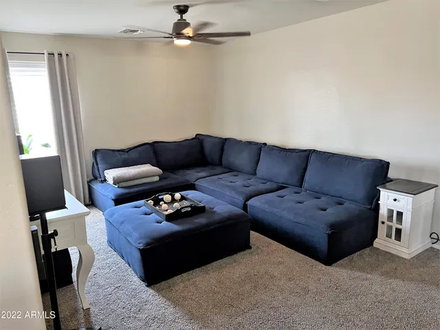 a room with wooden floor pool table and windows