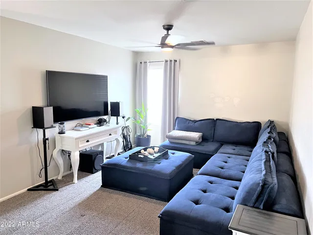 a living room with furniture a couch and a window