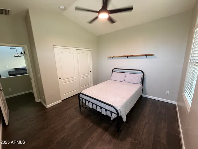 a bathroom with a sink a toilet a mirror and shower