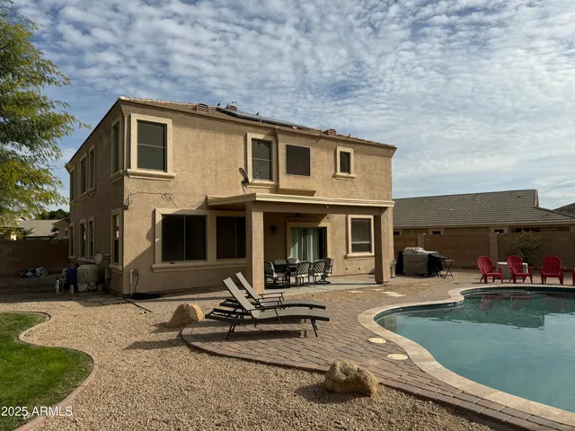 a view of a backyard with sitting area
