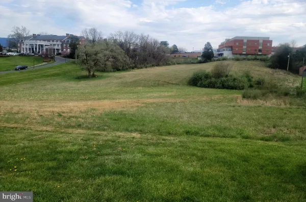 a view of a garden with a building in the background