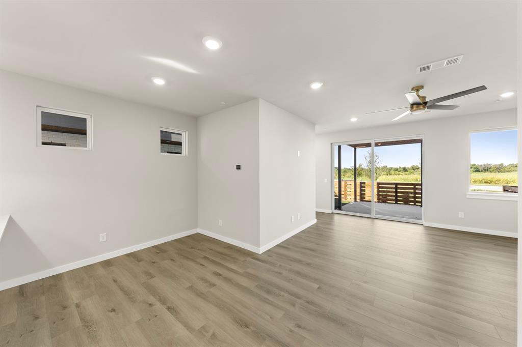 2013 Aldrich Road Celina, TX 75009 - Photo 13 of 40 a view of an empty room with wooden floor and a window
