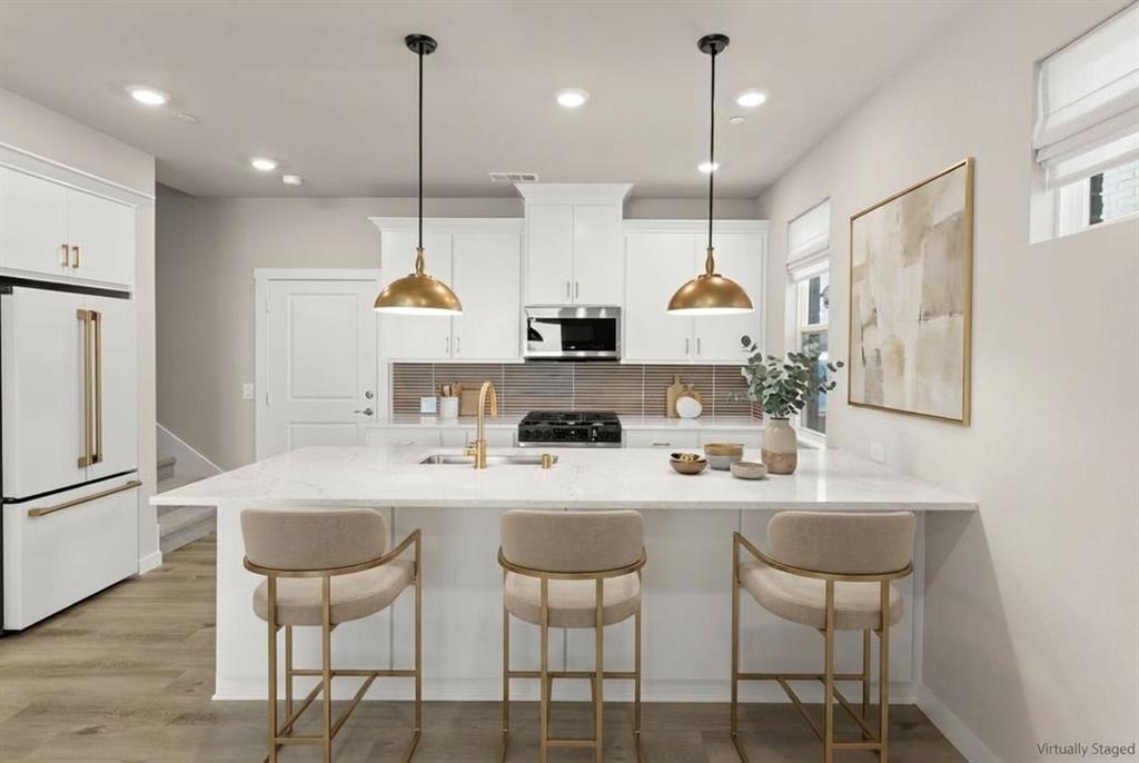2013 Aldrich Road Celina, TX 75009 - Photo 16 of 40 a kitchen with kitchen island appliances wooden floor and a center island