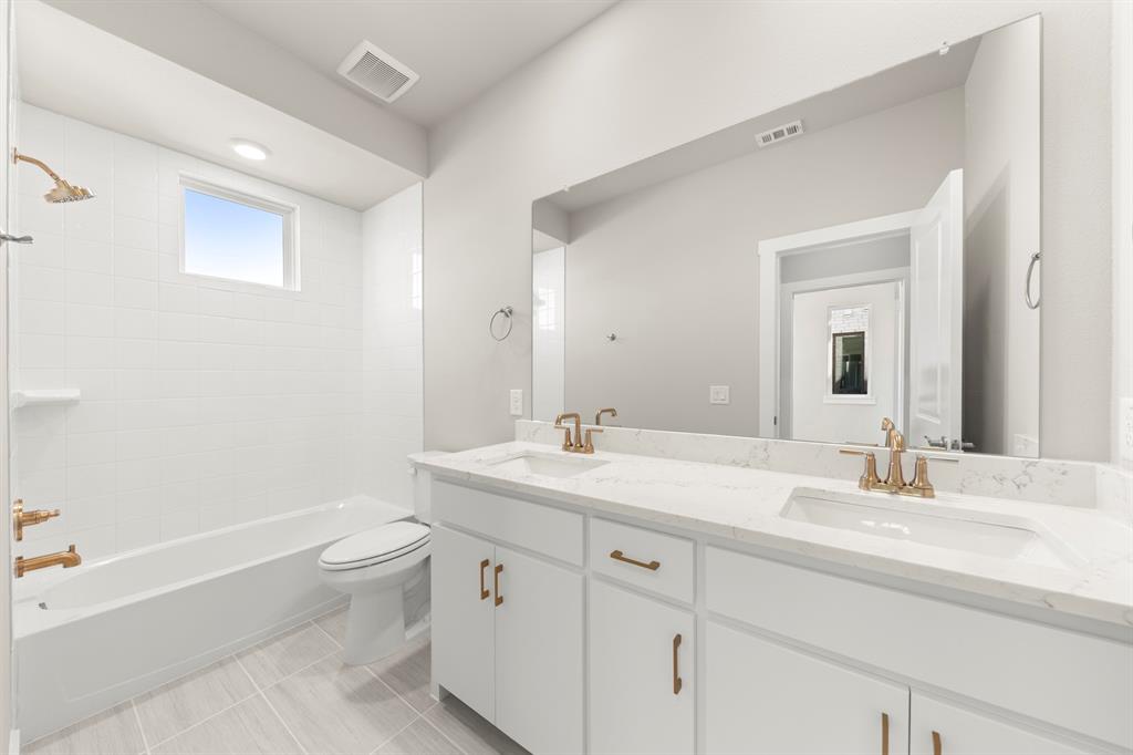 2013 Aldrich Road Celina, TX 75009 - Photo 25 of 40 a bathroom with a granite countertop sink a toilet and bathtub