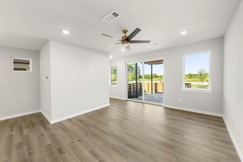 2013 Aldrich Road Celina, TX 75009 - Photo 7 of 40 an empty room with wooden floor and windows