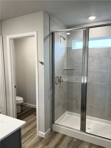 a bathroom with a glass door shower