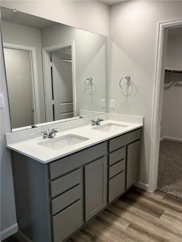 a bathroom with a double vanity sink and mirror