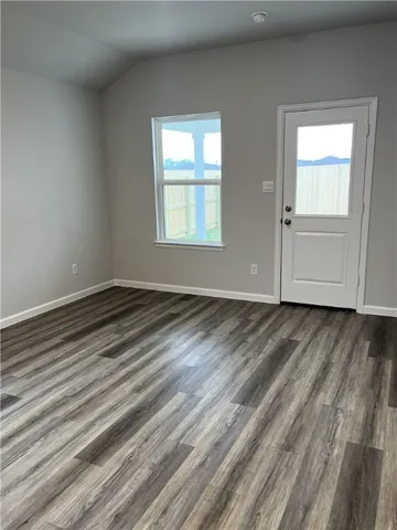 a view of room with window and hardwood floor