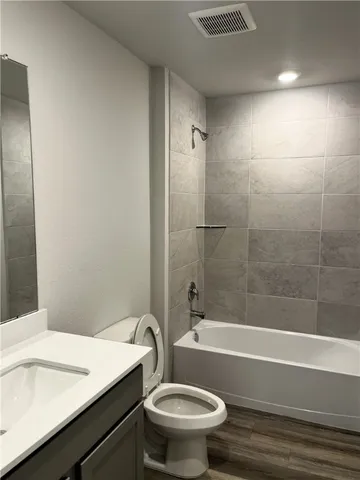 a bathroom with a sink a toilet and a bathtub