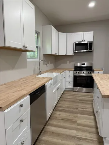 a large kitchen with granite countertop a stove and a sink