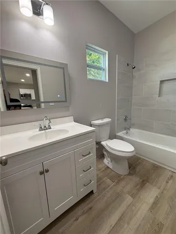 a bathroom with a toilet a sink and bathtub