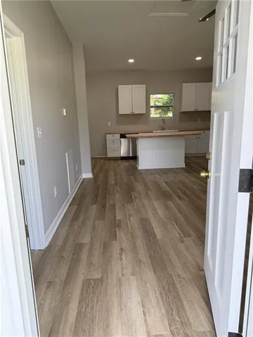 a view of a kitchen with wooden floor and a sink