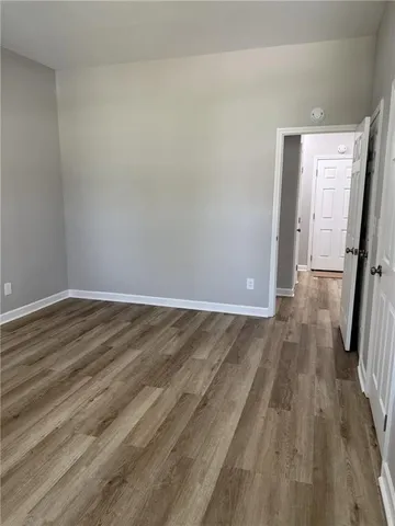 a view of a room with wooden floor and staircase