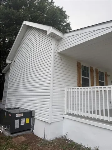 a view of a house with a small yard and wooden fence
