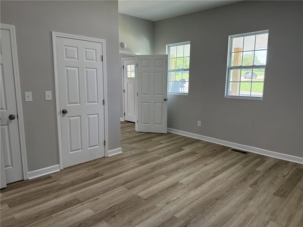 1300 Murphy Avenue LaGrange, GA 30240 - Photo 6 of 24 an empty room with wooden floor and windows