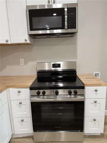 a stove top oven sitting inside of a kitchen
