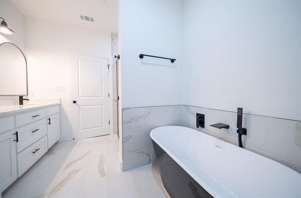 3411 Ladd Street Dallas, TX 75212 - Photo 10 of 14 a bathroom with a sink and a mirror