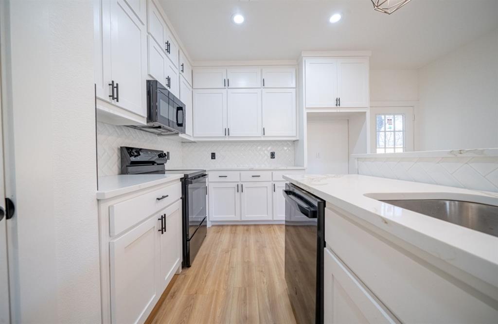 3411 Ladd Street Dallas, TX 75212 - Photo 5 of 14 a kitchen with white cabinets and appliances