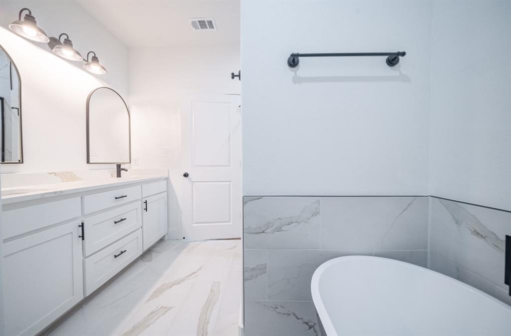 3411 Ladd Street Dallas, TX 75212 - Photo 9 of 14 a bathroom with a toilet sink and mirror