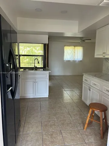 a room with a washing machine and sink