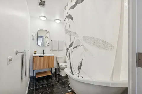 a bathroom with a toilet and a shower